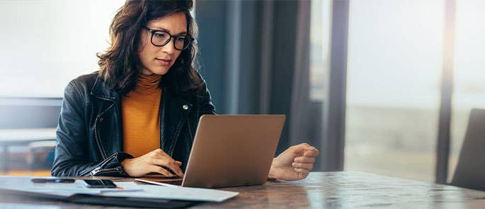 Teacher checking references on a laptop