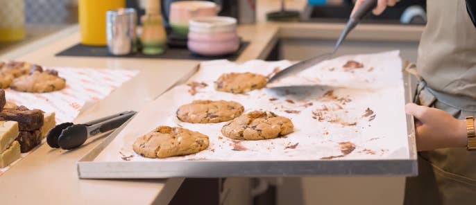 Employees placing freshly baked cookies on display