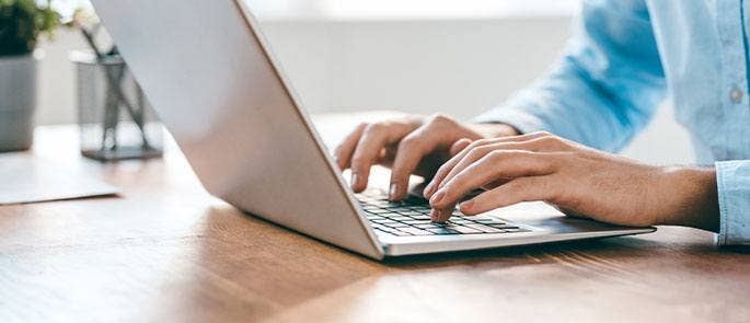 Typing on a laptop