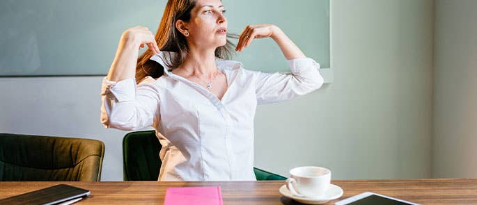 woman experiencing hot flush at work