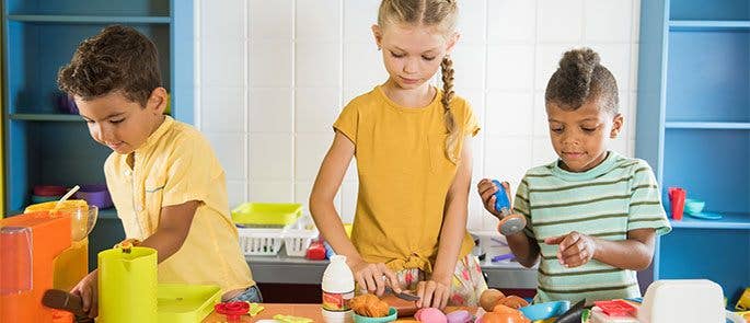 Children playing in a role-play kitchen