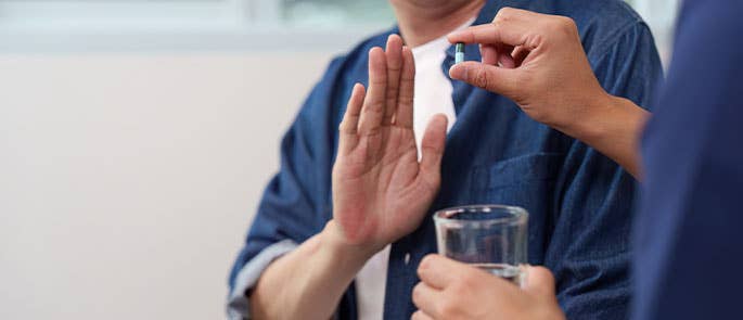 patient refusing to take medicine from healthcare professional