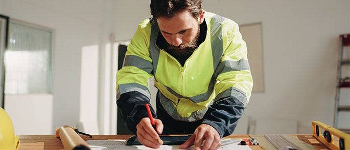 Construction worker planning how to carry out work safely