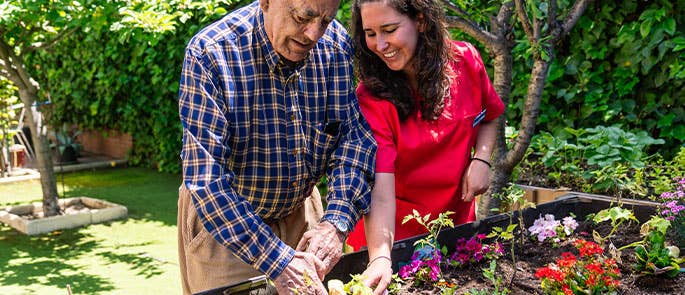 Occupational therapist helping patient with gardening hobby