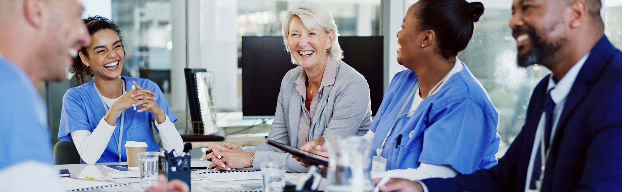 Care workers in discussion with managers and inspectors