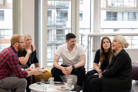 Group of colleagues talking at a table
