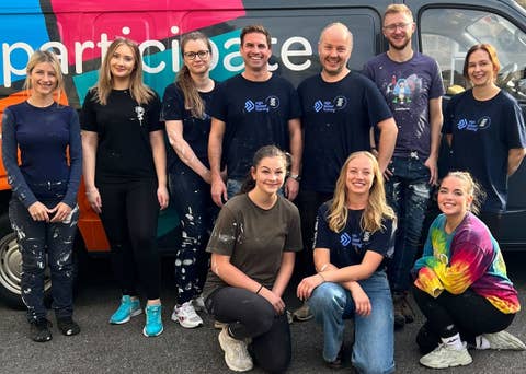 Photo of team wearing branded t-shirts